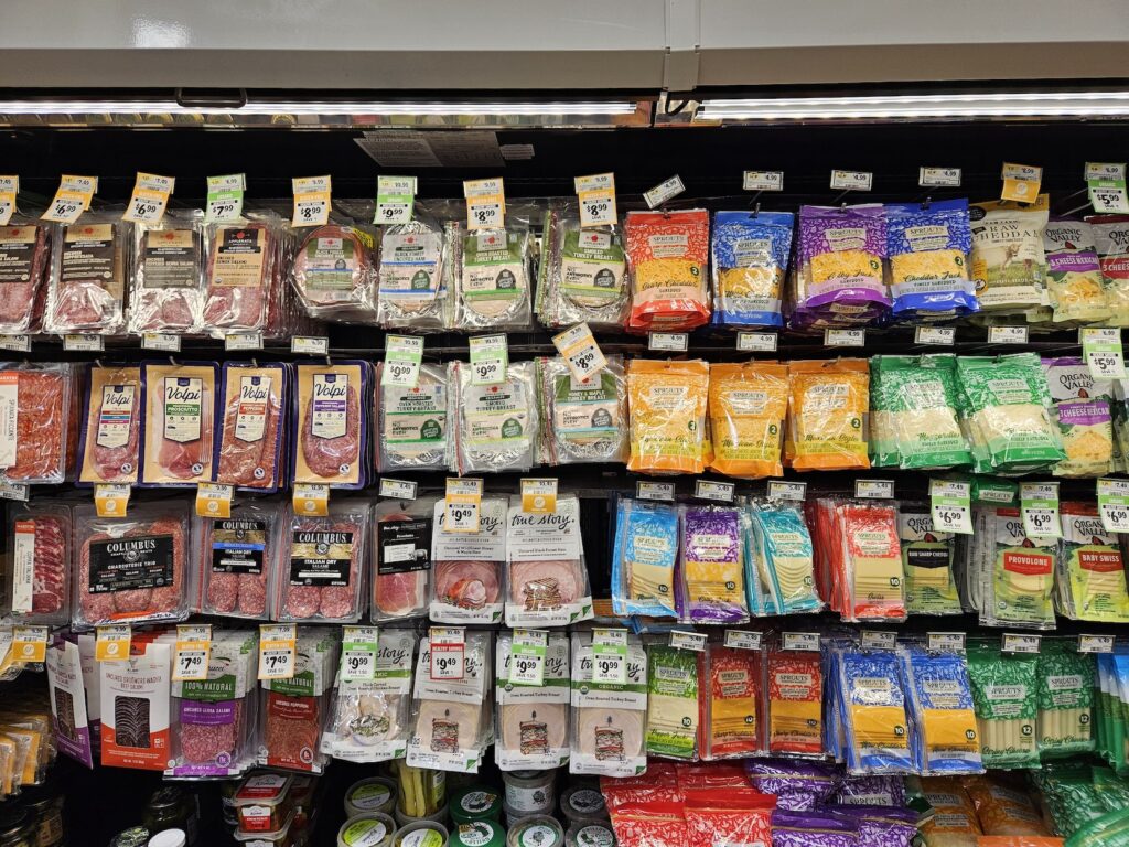 Packaged deli meats and cheeses at the grocery store.